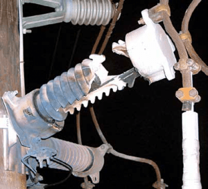 Article-2-July-22-newsletter-4-300x273 Article-2-July-22-newsletter-4-300x273 Overload on this failed arrester may have come from temporary overvoltage or from a lightning surge but could also have been that moisture ingress was underlying cause. Once shorted internally, fault current built the internal pressure to a level that fractured porcelain housing. Fracture could also have resulted from fault current above the unit’s rating. arrester Principal Failure Modes for Surge Arresters Article 2 July 22 newsletter 4