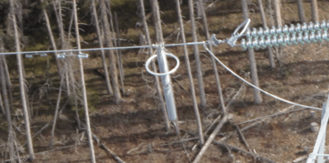 230-kV-Island-Falls-to-Key-Lake-I1K-TLSA-installation-including-armor-rods-under-clamp 230-kV-Island-Falls-to-Key-Lake-I1K-TLSA-installation-including-armor-rods-under-clamp line arrester Achieving Long Service Life for Transmission Line Arresters 230 kV Island Falls to Key Lake I1K TLSA installation including armor rods under clamp