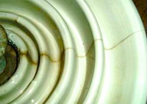 Radial cracking due to cement growth on porcelain insulators after 20 years of service. Insulator failure