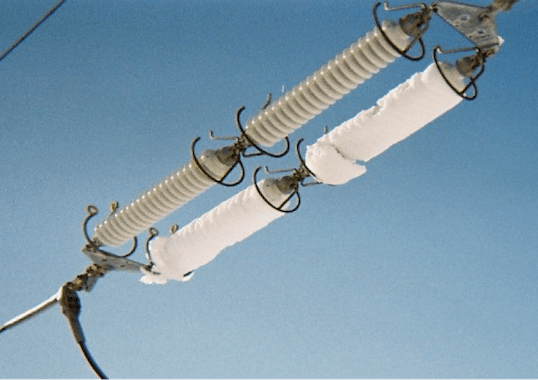 Fig. 1: Packed snow on horizontally mounted long-rod insulator strings.