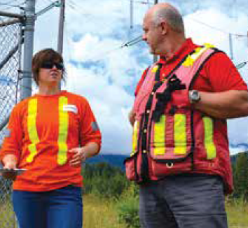 Loosley and Schlender discuss maintenance problems on ageing crossing span of Kootenay Lake.