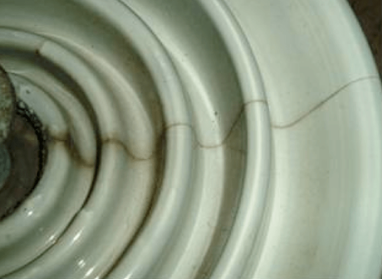 Fig. 7: Radial cracking (due to cement growth) seen on porcelain insulators after 20 years in service. 