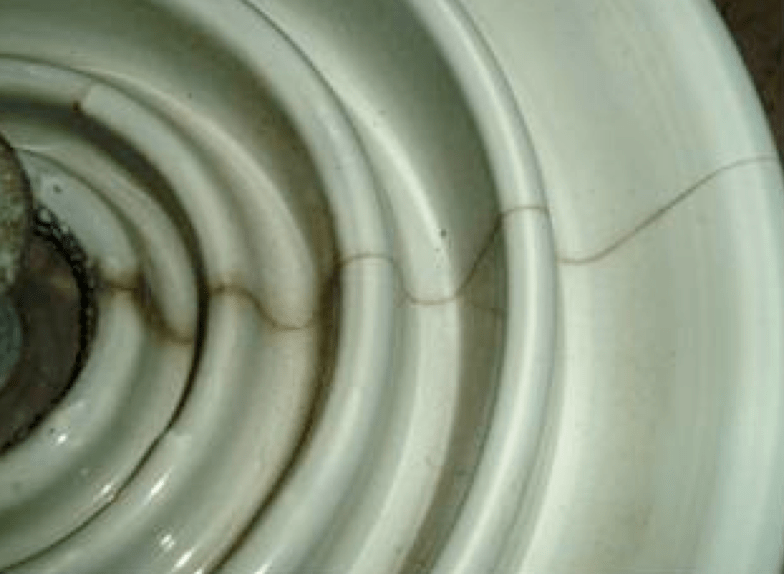 Fig. 7: Radial cracking (due to cement growth) seen on porcelain insulators after 20 years in service.